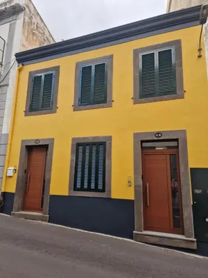 a yellow building with two doors on a street at Atlantic Garden Santa Luzia 44 in Funchal