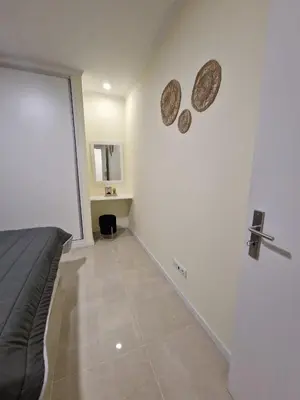 a bedroom with a bed and a cross on the wall at Atlantic Garden Santa Luzia 44 in Funchal
