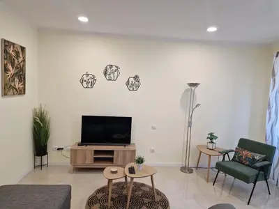 a living room with a flat screen tv on a wall at Atlantic Garden Santa Luzia 46 in Funchal