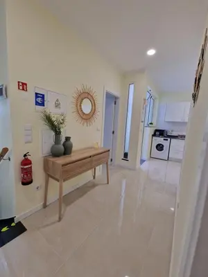 a living room with a table and a kitchen at Atlantic Garden Santa Luzia 46 in Funchal
