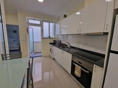 a kitchen with white cabinets and a stove top oven at Atlantic Garden Santa Luzia 46 in Funchal