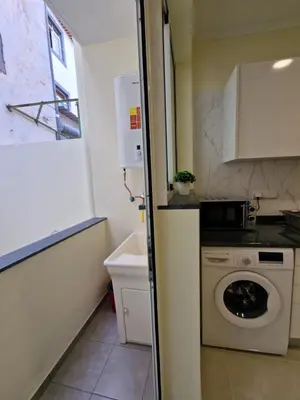 a small kitchen with a washing machine in it at Atlantic Garden Santa Luzia 46 in Funchal