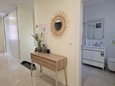 a bathroom with a table and a mirror and a sink at Atlantic Garden Santa Luzia 46 in Funchal