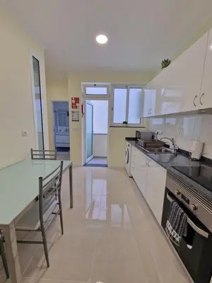 a kitchen with a table and a counter top at Atlantic Garden Santa Luzia 46 in Funchal