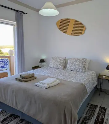 a living room with a couch and a table at Apartamento Sagres Sunset in Sagres