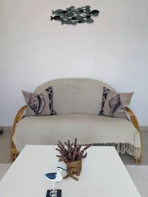 a living room with a couch and a table at Apartamento Sagres Sunset in Sagres