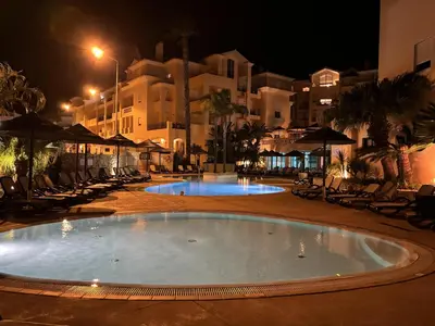 a large swimming pool in a resort at night at Seaview apartment Estrela da Luz Praia da Luz in Luz