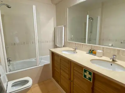 a bathroom with two sinks and a shower and a toilet at Seaview apartment Estrela da Luz Praia da Luz in Luz
