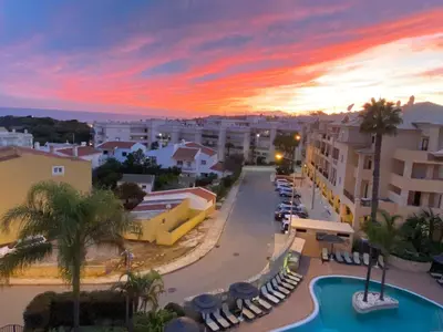 a view of a city street with a sunset at Seaview apartment Estrela da Luz Praia da Luz in Luz