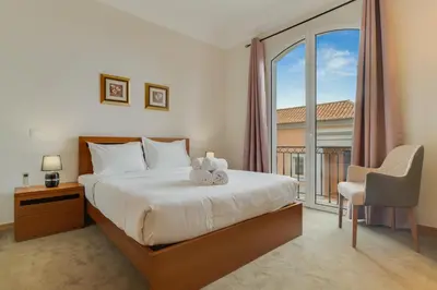 a bedroom with a bed and a large window at Villa Eve Palheiro Village by Holiday Rental Madeira in Funchal
