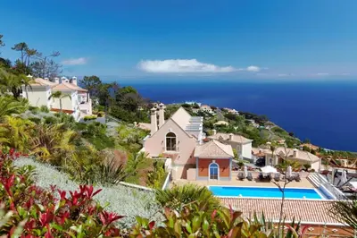an aerial view of a house and the ocean at Villa Eve Palheiro Village by Holiday Rental Madeira in Funchal