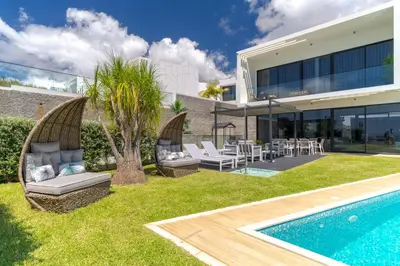 an exterior view of a house with a swimming pool at Luxury Diamond House by Holiday Rental Madeira in Funchal