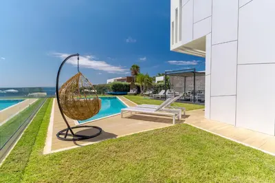 a metal swing on the side of a house at Luxury Diamond House by Holiday Rental Madeira in Funchal