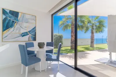 a dining room with a table and chairs and a view of the ocean at Luxury Diamond House by Holiday Rental Madeira in Funchal