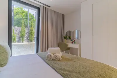 a bedroom with a bed with two towels on it at Luxury Diamond House by Holiday Rental Madeira in Funchal