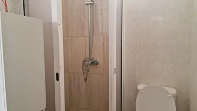 a shower in a bathroom with a toilet at Jose's cozy little home in Funchal
