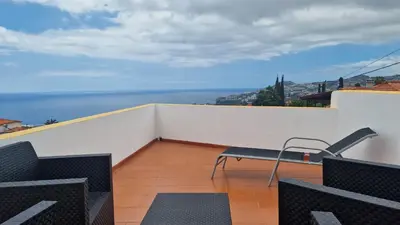 a balcony with chairs and a view of the ocean at Jose's cozy little home in Funchal