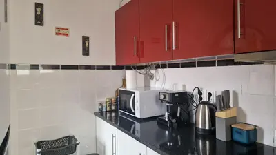 a kitchen with a counter top with a microwave at Jose's cozy little home in Funchal