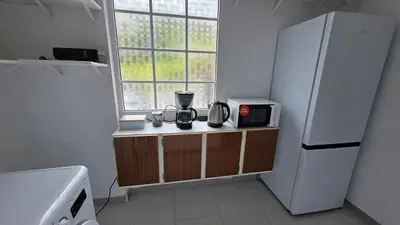 a kitchen with a white refrigerator and a window at The View in Santa Cruz