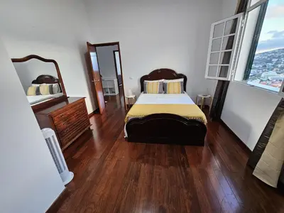 a bedroom with a bed and a large window at The View in Santa Cruz