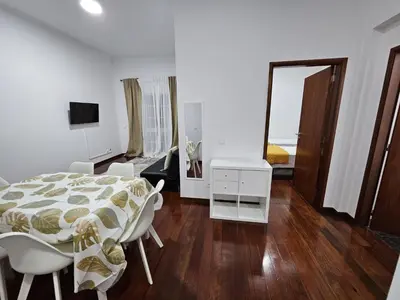 a white room with a bed and a table and chairs at The View in Santa Cruz