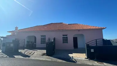 a white house with a red roof at The View in Santa Cruz