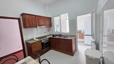 a small kitchen with wooden cabinets and a sink at The View in Santa Cruz