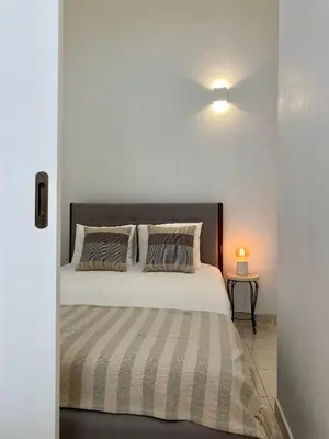 a bedroom with a large white bed with pillows at Casa da Aldeia in Bensafrim