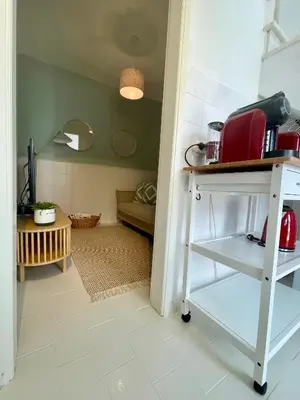 a kitchen with a table with a red appliance on it at Casa da Aldeia in Bensafrim