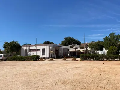 a large white building with a yard in front of it at Casa da Aldeia in Bensafrim