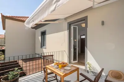 a patio with a table and chairs on a balcony at Bela de Santiago I by An Island Apart in Funchal