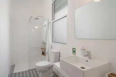 a white bathroom with a sink and a toilet at Bela de Santiago I by An Island Apart in Funchal