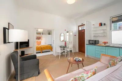 a living room with a couch and a kitchen at Bela de Santiago I by An Island Apart in Funchal