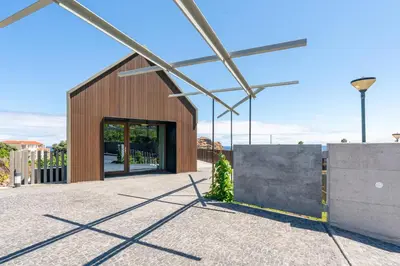 a large building with a large glass door at Doca Seca & Casca de Uva in Porto Moniz
