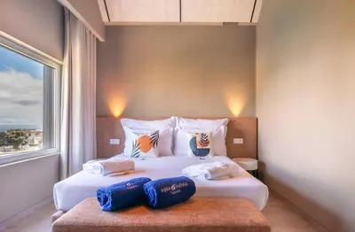 a bedroom with two beds and a window at Doca Seca & Casca de Uva in Porto Moniz