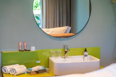 a bathroom with a sink and a mirror at Doca Seca & Casca de Uva in Porto Moniz