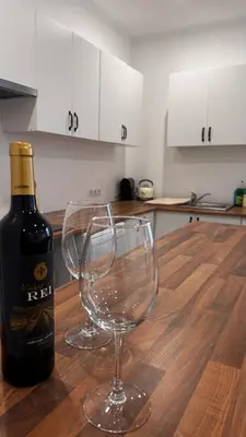 a bottle of wine and two wine glasses on a table at Revived in Porto da Cruz