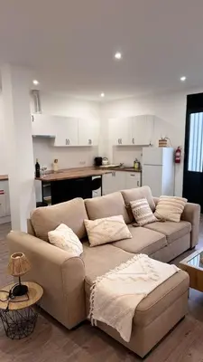 a living room with a couch and a kitchen at Revived in Porto da Cruz