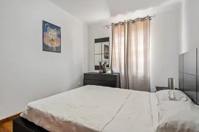 a bedroom with a white bed and a window at Linda Paisagem in Calheta