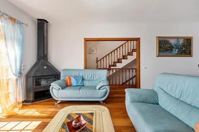 a living room with a couch and a chair at Linda Paisagem in Calheta