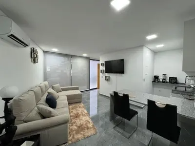 a living room with a couch and a table at Villa Castanho II in Calheta
