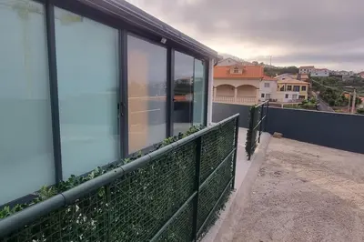 a balcony of a building with plants on it at Villa Castanho II in Calheta