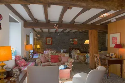 a living room filled with furniture and a stone wall at Casa da Madalena do Mar in Madalena do Mar
