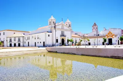 a church with a reflection in a pond in front of it at Boa Vista - Fairview Island in Lagos