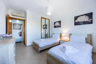 a hotel room with two beds and a kitchen at Boa Vista - Fairview Island in Lagos