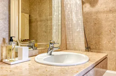a bathroom with a sink and a mirror at Casa das Bromélias, a Home in Madeira in Funchal