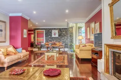 a living room filled with furniture and a fireplace at Casa das Bromélias, a Home in Madeira in Funchal