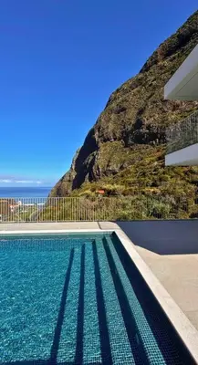 a swimming pool in front of a mountain at Cardais Paradise View in São Vicente