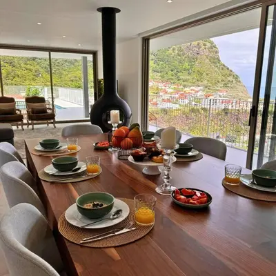 a wooden table with food on it in a living room at Cardais Paradise View in São Vicente