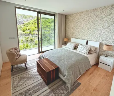 a bedroom with a bed and a chair and a window at Cardais Paradise View in São Vicente